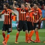Shakhtar s Darijo Srna and Shakhtar s Olexandr Kucher celebrate after scoring during a soccer game b